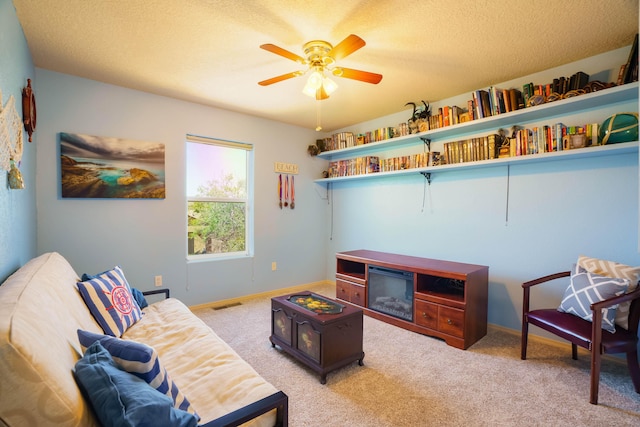 6105 Loro Ave NW, Albuquerque, NM 87114 - living area with carpet flooring, a ceiling fan, a textured ceiling, and baseboards