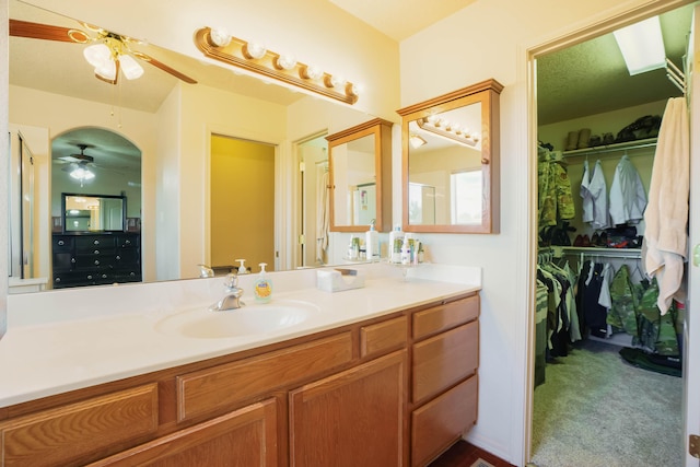 6105 Loro Ave NW, Albuquerque, NM 87114 - bathroom featuring a ceiling fan, vanity, and a walk in closet