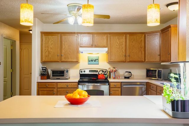 6105 Loro Ave NW, Albuquerque, NM 87114 - kitchen featuring appliances with stainless steel finishes, under cabinet range hood, a ceiling fan, hanging light fixtures, and light countertops
