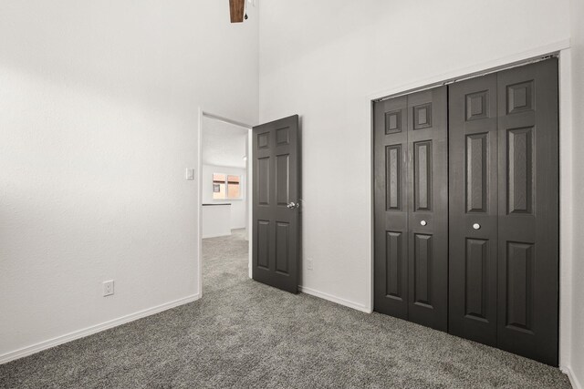 1616 Vail Pl SE, Albuquerque, NM 87106 - unfurnished bedroom featuring carpet floors, a closet, a high ceiling, baseboards, and ceiling fan
