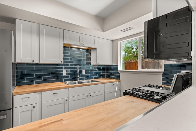 1616 Vail Pl SE, Albuquerque, NM 87106 - kitchen featuring wood counters, a sink, black microwave, and backsplash