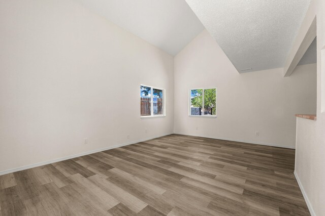 1616 Vail Pl SE, Albuquerque, NM 87106 - unfurnished room featuring wood finished floors, high vaulted ceiling, and baseboards