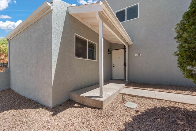 1616 Vail Pl SE, Albuquerque, NM 87106 - doorway to property with stucco siding