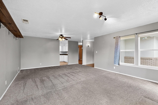 2110 Twisted Juniper Rd SE, Rio Rancho, NM 87124 - unfurnished room featuring a ceiling fan, a textured ceiling, carpet flooring, and baseboards