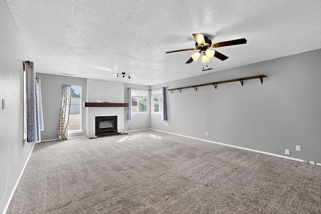 2110 Twisted Juniper Rd SE, Rio Rancho, NM 87124 - unfurnished living room with a textured ceiling, a ceiling fan, a fireplace, baseboards, and carpet flooring