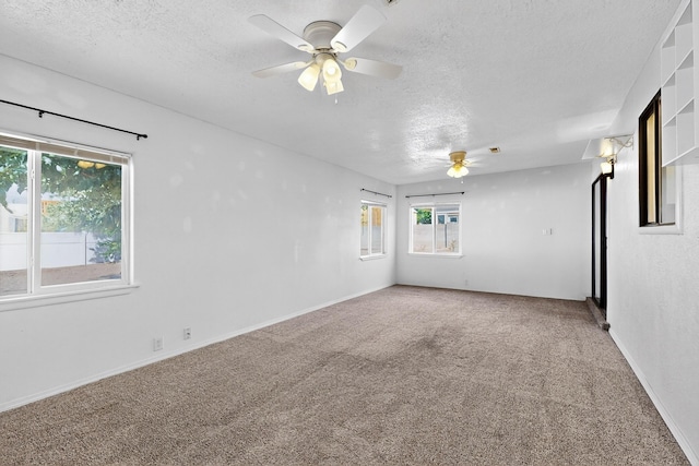 2110 Twisted Juniper Rd SE, Rio Rancho, NM 87124 - spare room featuring a textured ceiling, a ceiling fan, carpet floors, and baseboards