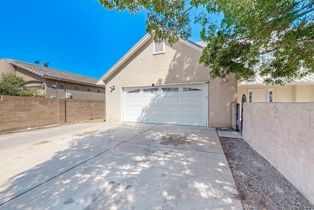 717 Monterrey Rd NE, Rio Rancho, NM 87144 - view of side of property with stucco siding, driveway, and an attached garage