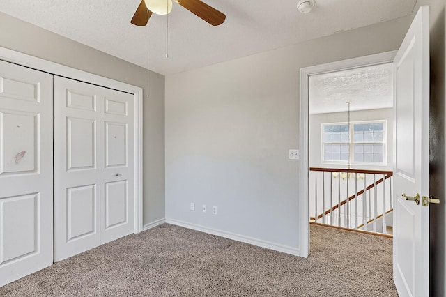 717 Monterrey Rd NE, Rio Rancho, NM 87144 - unfurnished bedroom with carpet flooring, a textured ceiling, a closet, and ceiling fan