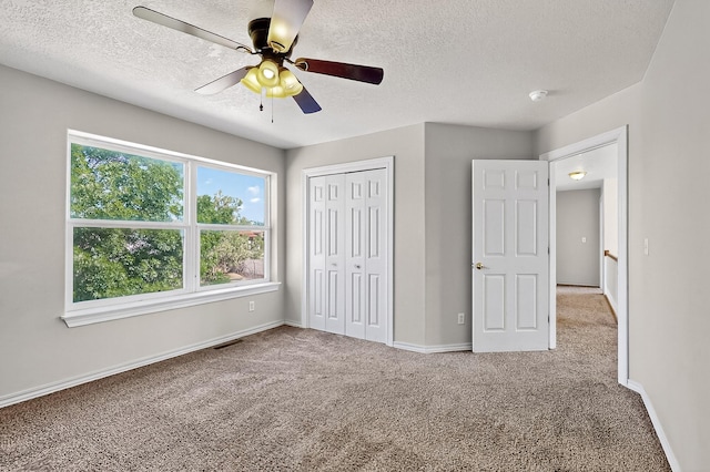 717 Monterrey Rd NE, Rio Rancho, NM 87144 - unfurnished bedroom with a textured ceiling, carpet floors, a closet, and ceiling fan