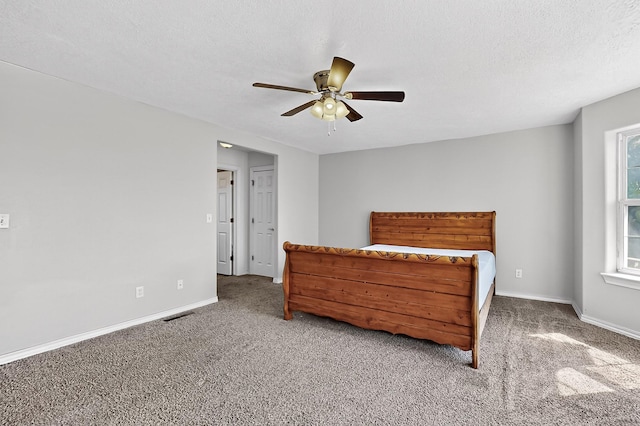 717 Monterrey Rd NE, Rio Rancho, NM 87144 - bedroom featuring carpet, a ceiling fan, and a textured ceiling