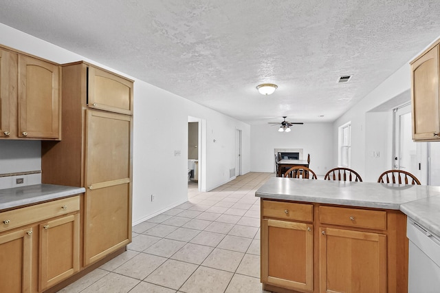 717 Monterrey Rd NE, Rio Rancho, NM 87144 - kitchen featuring ceiling fan, dishwasher, light tile patterned floors, light countertops, and a textured ceiling