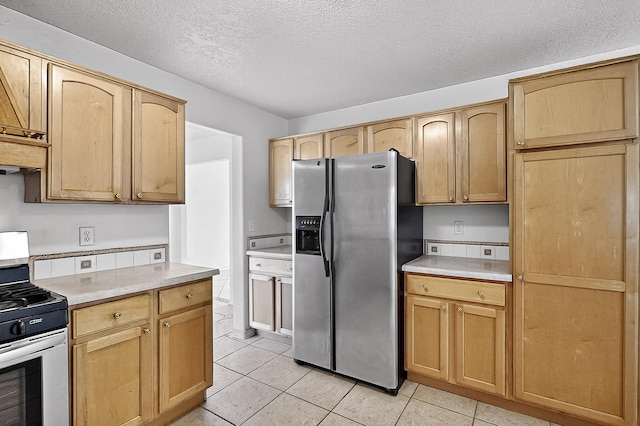 717 Monterrey Rd NE, Rio Rancho, NM 87144 - kitchen featuring stainless steel appliances, light countertops, a textured ceiling, light tile patterned flooring, and light brown cabinets