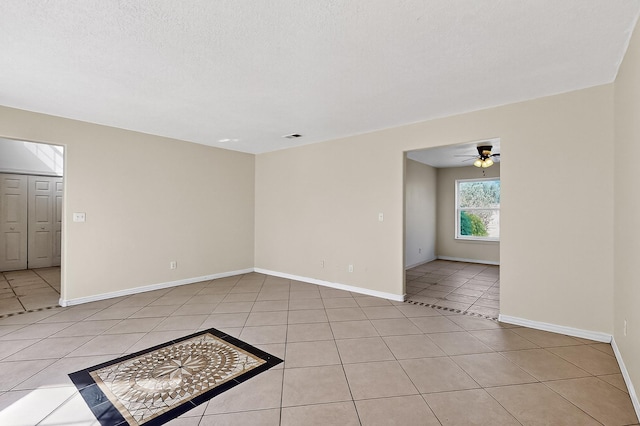 717 Monterrey Rd NE, Rio Rancho, NM 87144 - unfurnished room with light tile patterned floors, a ceiling fan, and a textured ceiling