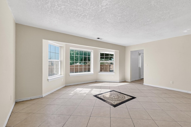 717 Monterrey Rd NE, Rio Rancho, NM 87144 - empty room with light tile patterned flooring and a textured ceiling