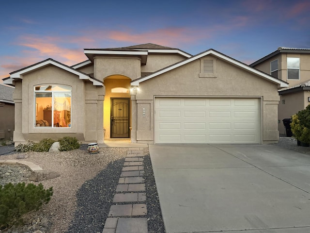 4532 Ambrose Alday Loop SE, Rio Rancho, NM 87124 - view of front facade with stucco siding, an attached garage, and driveway