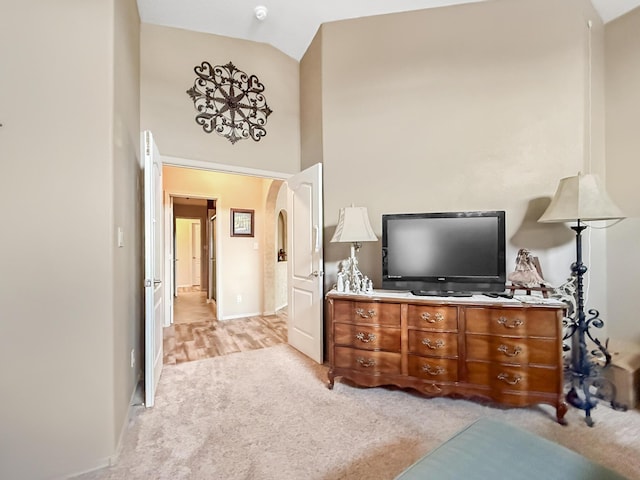 4532 Ambrose Alday Loop SE, Rio Rancho, NM 87124 - bedroom with light carpet, arched walkways, baseboards, and high vaulted ceiling