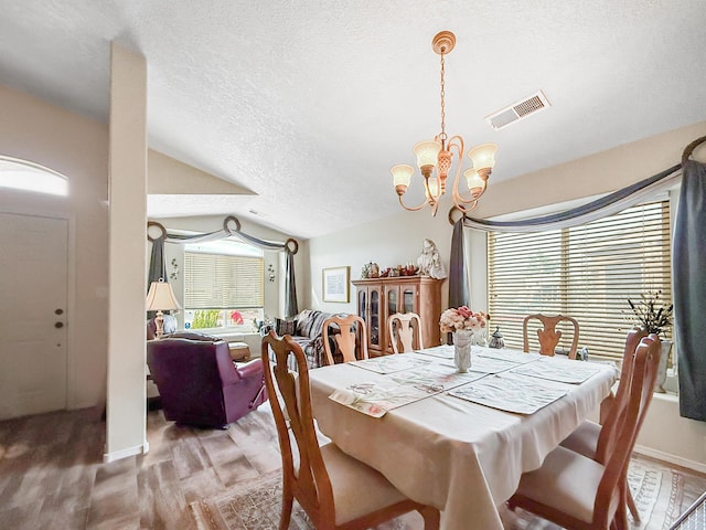 4532 Ambrose Alday Loop SE, Rio Rancho, NM 87124 - dining space featuring vaulted ceiling, a chandelier, a textured ceiling, and baseboards