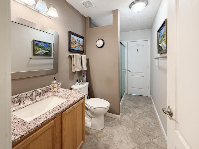 4532 Ambrose Alday Loop SE, Rio Rancho, NM 87124 - full bathroom with vanity, toilet, a shower stall, tile patterned floors, and a textured ceiling