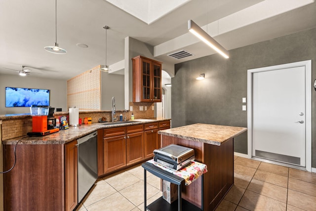 2625 Globe Ct NE, Rio Rancho, NM 87124 - kitchen featuring dishwasher, brown cabinets, tasteful backsplash, a sink, and light tile patterned flooring