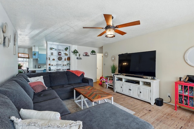 2724 Pennsylvania St NE, Albuquerque, NM 87110 - living area with ceiling fan, light wood finished floors, and a textured ceiling