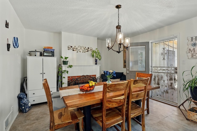 2724 Pennsylvania St NE, Albuquerque, NM 87110 - dining area featuring a chandelier and a textured ceiling