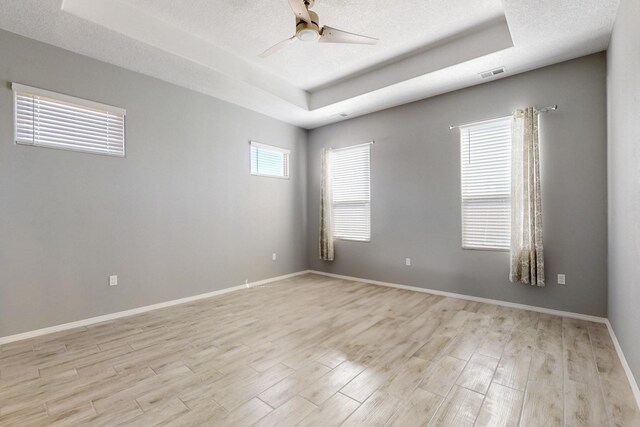 7037 Cleary Loop NE, Rio Rancho, NM 87144 - unfurnished room featuring a raised ceiling, ceiling fan, light wood-style floors, and baseboards