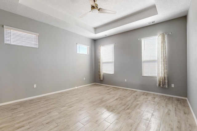 7037 Cleary Loop NE, Rio Rancho, NM 87144 - empty room with a raised ceiling, ceiling fan, and light wood-style floors