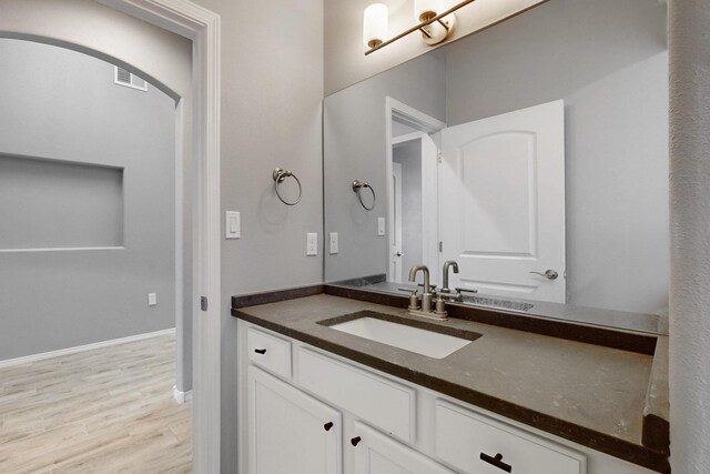 7037 Cleary Loop NE, Rio Rancho, NM 87144 - bathroom featuring vanity, wood finished floors, and baseboards