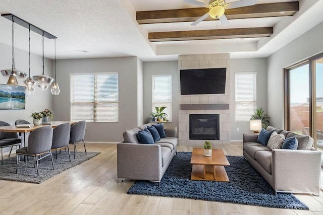 7037 Cleary Loop NE, Rio Rancho, NM 87144 - living room with healthy amount of natural light, wood finished floors, a ceiling fan, baseboards, and beam ceiling