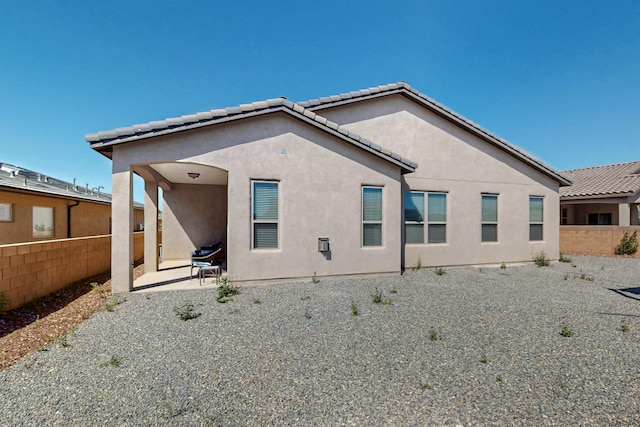 7037 Cleary Loop NE, Rio Rancho, NM 87144 - back of property featuring stucco siding, a patio area, and a tiled roof