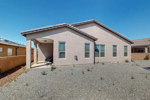7037 Cleary Loop NE, Rio Rancho, NM 87144 - back of property featuring stucco siding, a patio, and a tiled roof