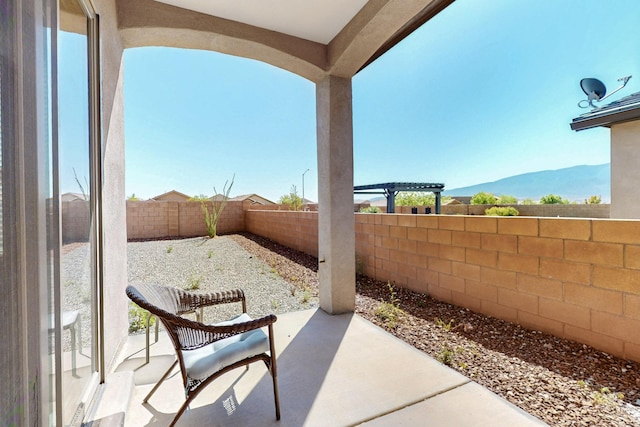 7037 Cleary Loop NE, Rio Rancho, NM 87144 - fenced backyard featuring a patio and a mountain view