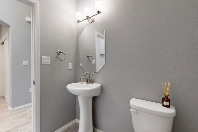 7037 Cleary Loop NE, Rio Rancho, NM 87144 - bathroom with toilet, wood finished floors, and baseboards