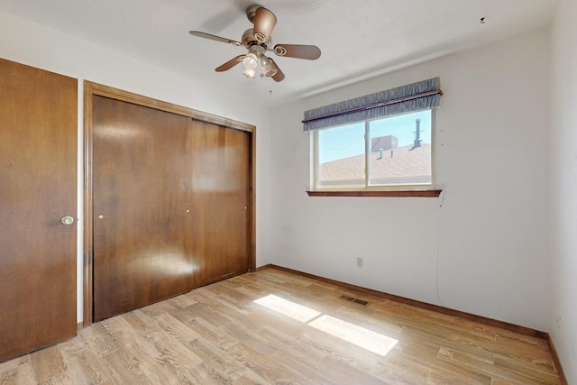 12304 Phoenix Ave NE, Albuquerque, NM 87112 - unfurnished bedroom with a closet, light wood-style floors, a ceiling fan, and baseboards