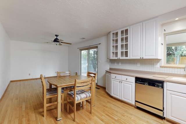 12304 Phoenix Ave NE, Albuquerque, NM 87112 - kitchen with dishwasher, white cabinetry, tasteful backsplash, light wood-style flooring, and a textured ceiling