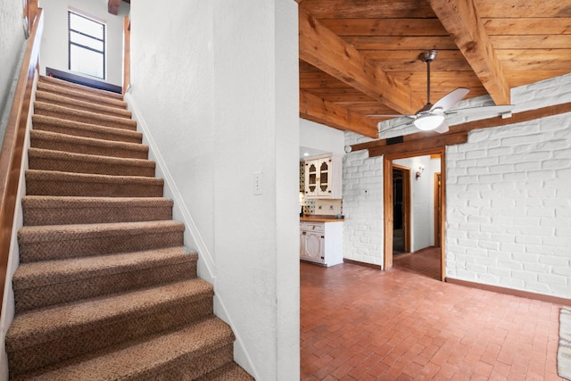 234 Horton Ln NW, Albuquerque, NM 87114 - stairway with wooden ceiling with exposed beams, a ceiling fan, brick floors, baseboards, and brick wall