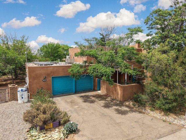 234 Horton Ln NW, Albuquerque, NM 87114 - view of front of property with stucco siding, a garage, and driveway