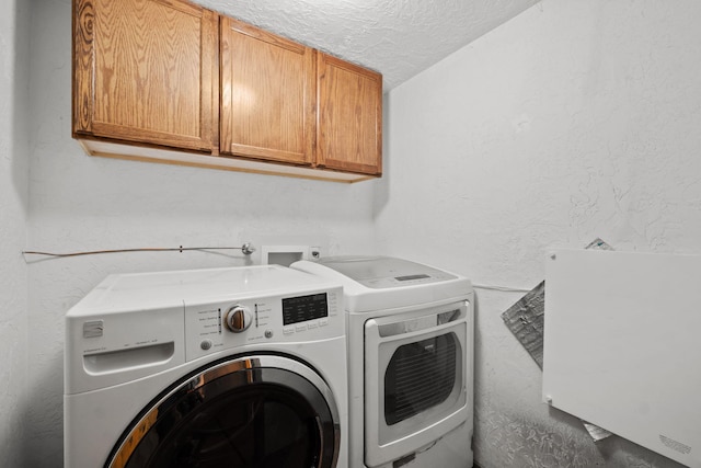 234 Horton Ln NW, Albuquerque, NM 87114 - laundry area with cabinet space, washing machine and clothes dryer, a textured ceiling, and a textured wall