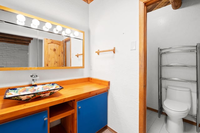 234 Horton Ln NW, Albuquerque, NM 87114 - bathroom featuring toilet, vanity, tile patterned flooring, and baseboards