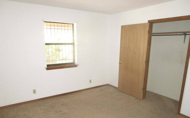 212 E Tingley Ave, Moriarty, NM 87035 - unfurnished bedroom featuring light colored carpet and a closet