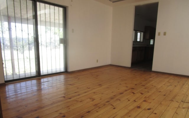 212 E Tingley Ave, Moriarty, NM 87035 - empty room with hardwood / wood-style flooring and baseboards
