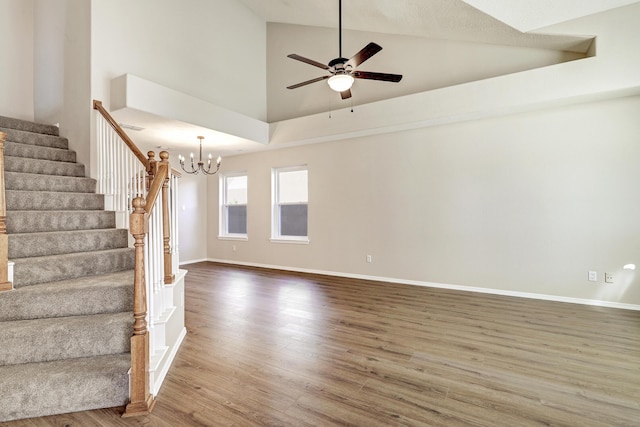 6923 Luz Del Sol Pl NW, Albuquerque, NM 87114 - unfurnished room with stairway, wood finished floors, a ceiling fan, a chandelier, and high vaulted ceiling