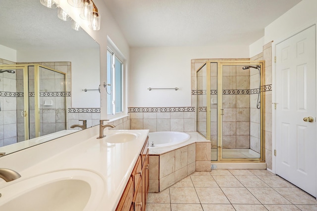 6923 Luz Del Sol Pl NW, Albuquerque, NM 87114 - bathroom with a garden tub, tile patterned flooring, a shower stall, double vanity, and a textured ceiling