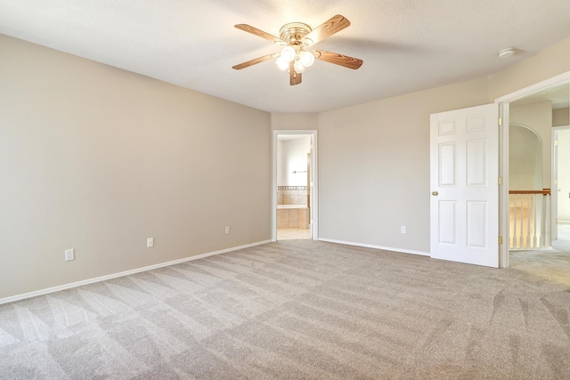 6923 Luz Del Sol Pl NW, Albuquerque, NM 87114 - unfurnished bedroom with carpet flooring, baseboards, ensuite bath, and ceiling fan