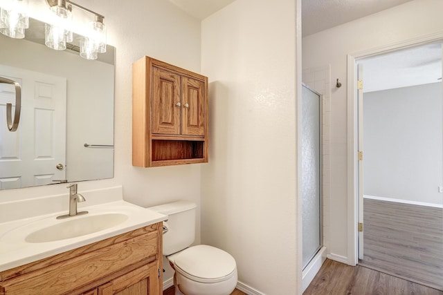 6923 Luz Del Sol Pl NW, Albuquerque, NM 87114 - bathroom with a stall shower, vanity, wood finished floors, and toilet