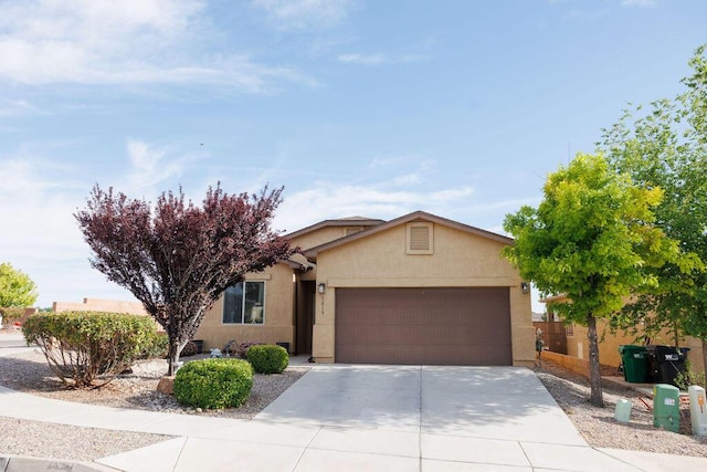 1019 Jacobs Dr NE, Rio Rancho, NM 87144 - view of front of property featuring a garage, stucco siding, and driveway