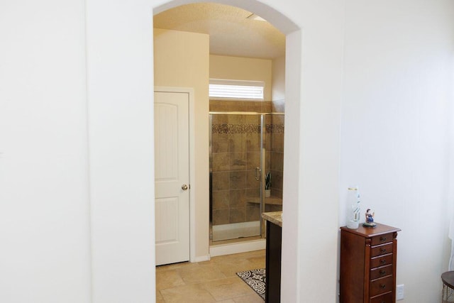 1019 Jacobs Dr NE, Rio Rancho, NM 87144 - corridor featuring arched walkways and light tile patterned floors