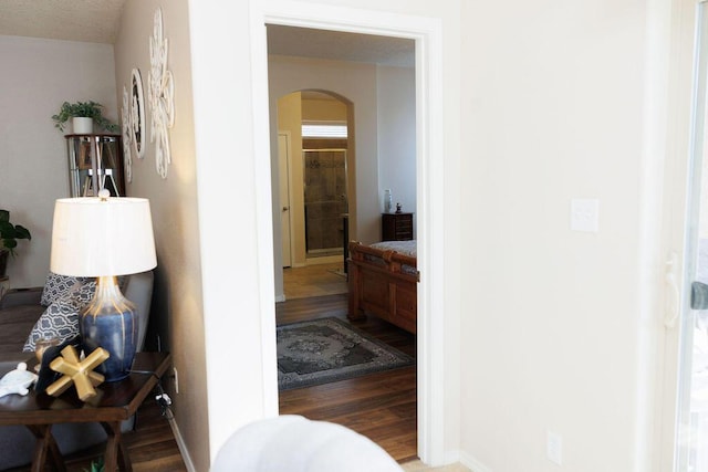 1019 Jacobs Dr NE, Rio Rancho, NM 87144 - hall with arched walkways, wood finished floors, and baseboards