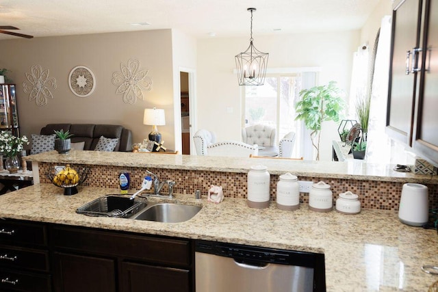 1019 Jacobs Dr NE, Rio Rancho, NM 87144 - kitchen featuring stainless steel dishwasher, a sink, a chandelier, tasteful backsplash, and light stone counters