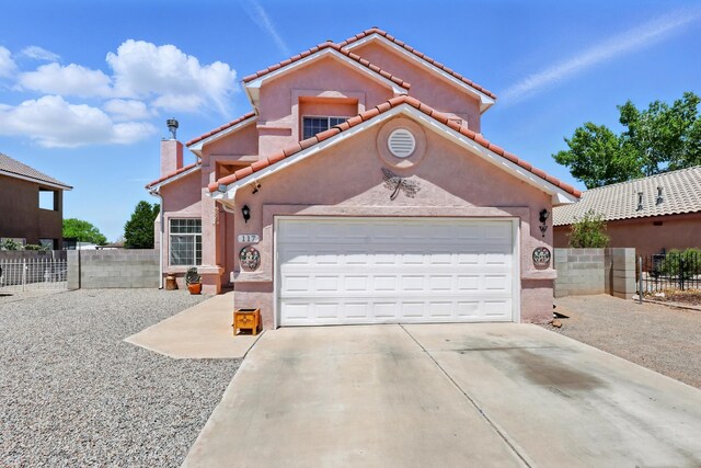 117 El Mundo Rd, Rio Communities, NM 87002 - mediterranean / spanish-style home featuring concrete driveway, stucco siding, a garage, and a chimney